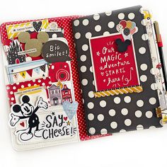 an open notebook with mickey mouse magnets on the front and back cover, along with other stickers