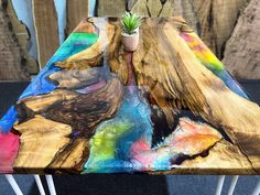 a table made out of wood and painted with different colors