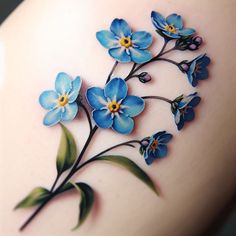 a tattoo with blue flowers on it