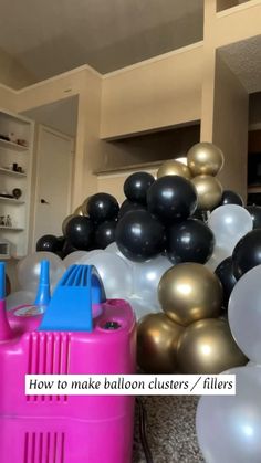 balloons are stacked on top of each other in a room filled with black and white balloons