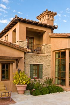 an outside view of a house with potted plants