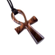 This reversible large wooden Ankh pendant is artfully hand carved in Cocobolo, an exotic hardwood that originates from Mexico, a wood highly diverse in colors and grain, making this pendant unique and one of a kind. This particular exotic wood tends to darken over time, therefore by the time you will receive this pendant the wood might have settled into darker reddish-brown tones. The pendant is sealed with multiple layers of glossy wood lacquer that add a lot of shine to the piece. - The pendant measures approximately 2.5" (6.3cm) tall by 1.4" (3.5cm) wide. - This pendant comes with a 30" (78cm) black satin cord that you can tie yourself as short or as long as you would like, ready to wear. We have more hand carved wooden ANKH PENDANTS here: https://www.etsy.com/shop/GatewayAlpha?search_q Egyptian Cross, Ankh Pendant, Ankh Necklace, Shark Necklace, African Jewelry, Wood Pendant, Wood Jewellery, Men Necklace, Body Lotion