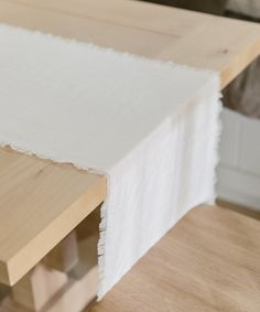 a wooden table with a white cloth on it