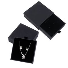 two necklaces in a black box on a white background