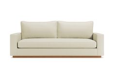 a white couch with two pillows on it