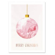 a pink christmas ornament hanging from a gold ball on a white background with the words merry christmas