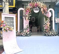 an entrance to a wedding venue decorated with flowers