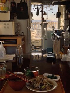 a table topped with plates of food next to a window