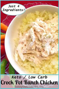 a white bowl filled with rice and chicken on top of a red table cloth next to carrots