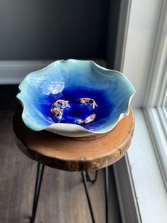 a blue bowl sitting on top of a wooden table