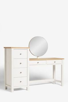 a white dressing table with a mirror on top and drawers below the vanity, against a plain background