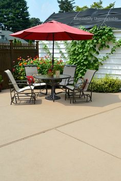 a patio with chairs and an umbrella