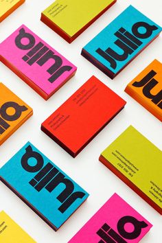 many different colored business cards on top of each other with the word uno written in black