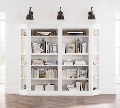 a white bookcase with many books on it