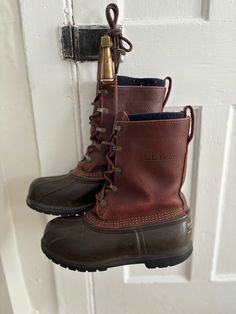 These vintage style L. L. Bean duck boots are a classic style for your wardrobe! Pair with a spring rain jacket, fall utility jacket, or a wintery parka for an almost all season look. These boots are marked men's size 7 and feature a leather shell with a fleece lining. The metal buckles are showing some discoloration and wear as pictured, and the labels on the back of the boot are faded. No holes or stains noted. Items are vintage style and are sold and pictured as is. Please message directly with any questions. Duck Rain Boots Men, Brown Rain Boots With Round Toe For Fall, Brown Round Toe Rain Boots For Fall, Fall Weatherproof Waterproof Boots, Weatherproof Waterproof Boots For Cold Weather In Fall, Classic Waterproof Boots For Winter Hiking, Classic Weatherproof Boots For Fall, Classic Waterproof Boots For Fall Outdoor Activities, Classic Waterproof Hiking Boots For Fall