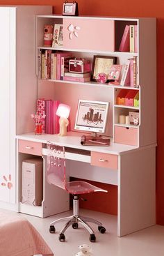 a pink and white desk in a room with an open bookcase on the wall