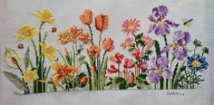 a cross stitch pattern with flowers on it