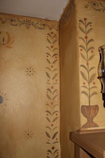 a bathroom with a sink and wallpaper on the walls