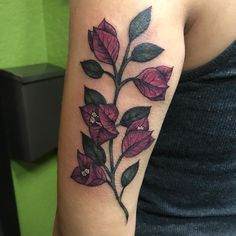 a woman with a flower tattoo on her arm