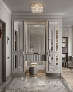 an elegant bathroom with marble flooring and white walls, along with chandelier