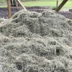 a pile of hay sitting in the middle of a field