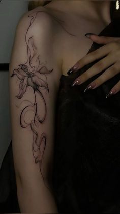 a woman's arm with a flower tattoo on the left side of her body