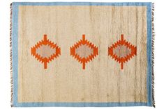 an orange and blue rug with three different designs on it's sides, including one in the middle