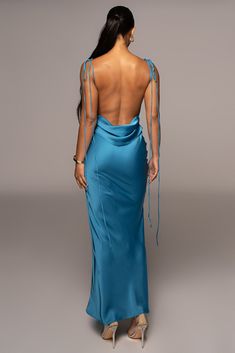 Our new Aqua Blue Irresistible Satin Maxi Dress serves timeless glamour in a sleek maxi design crafted of ultra smooth satin fabric. This dazzling satin dress features a chic cowl neckline with adjustable bow-tie shoulder straps and a low draped cowl back showing off some skin. Mermaid hem. No stretch. Single lined. Materials: 100% PolyesterLength: (full) 61 in.Product Origin: ImportedWashing Instructions: Hand wash coldUndergarments: Pastie cover upModel is wearing size S Satin Blue Prom Dress, Classy Maxi Dress Gowns, Backless Blue Dress, Ocean Blue Dress, Blue Satin Maxi Dress, Blue Backless Dress, Azure Dress, Aqua Blue Dress, Blue Satin Dress