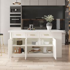 a white kitchen with an island in the middle and lots of counter space on one side