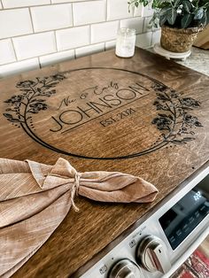 a wooden cutting board sitting on top of a stove