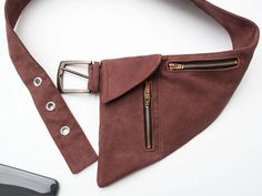 a brown suede belt with metal zippers