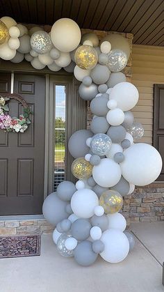 a bunch of balloons that are in front of a door