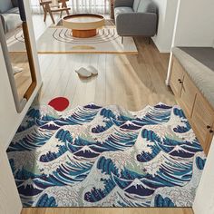 a living room filled with furniture and a rug on top of a hard wood floor