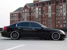 a black car parked in front of a building