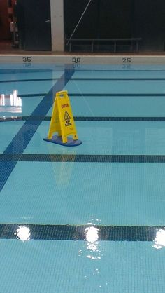 an image of a swimming pool with caution signs