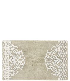 a white rug with an intricate design on the front and back side, against a white background