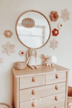 a dresser with a mirror and stuffed animals on it in a child's room