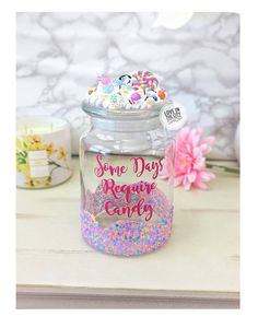 a jar filled with sprinkles sitting on top of a table