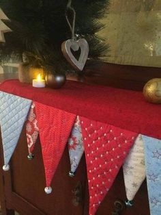 a christmas tree is decorated with red, white and blue pennants