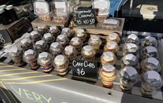 an assortment of desserts and pastries on display for sale