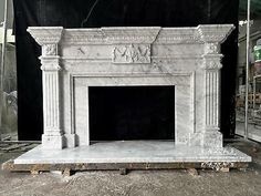 a white marble fireplace in a room