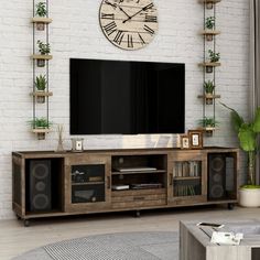 a living room with a large clock mounted to the wall above it's entertainment center