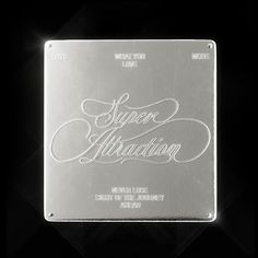 a metal plaque with the words super attraction written in cursive writing on it