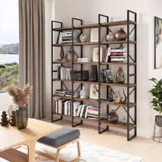 a living room filled with furniture and a book shelf in front of a large window