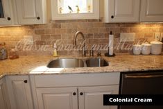 a kitchen with white cabinets and granite counter tops, along with a stainless steel dishwasher