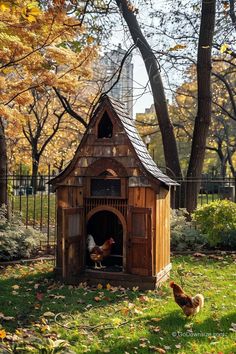 two chickens in a small wooden chicken house on the grass next to trees with yellow leaves