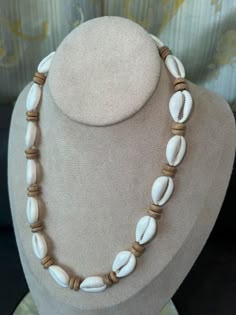 "This Native Treasure Authentic Tropical  Jewelry Cowrie Shell Necklace is Beautifully Hand-Crafted in our Tropical Jewelry Shop by our own Native Island Artisans using up to  1\" Long Hand-Selected Super  Class 'A' Quality Cowrie Shells.  Select your size from 14\" to 24\" inch length, priced accordingly. 8mm (5/16\") Real wood Coco Beads and  'Good Karma' Cowrie Shells Indigenous to  the Powder White Beaches of the Philippines. Perfect to take that Tropical Feeling with You! Truly Native Treas White Beach Jewelry With Wooden Beads, White Wooden Beads Jewelry For Beach, White Wooden Beads Jewelry For The Beach, White Wooden Beads Necklace For Vacation, Cowrie Shell Jewelry Necklaces, Cowrie Necklace, Afro Jewelry, Wood Beads Jewelry, Cowrie Shell Jewelry