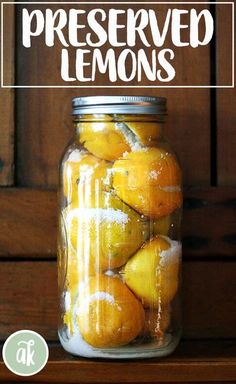 a jar filled with lemons sitting on top of a wooden table