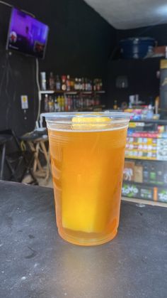 a plastic cup filled with liquid sitting on top of a table