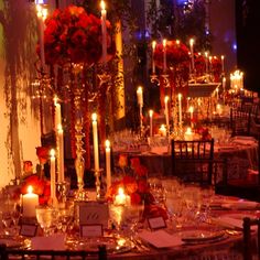 a long table with candles and flowers on it is set up for a formal function